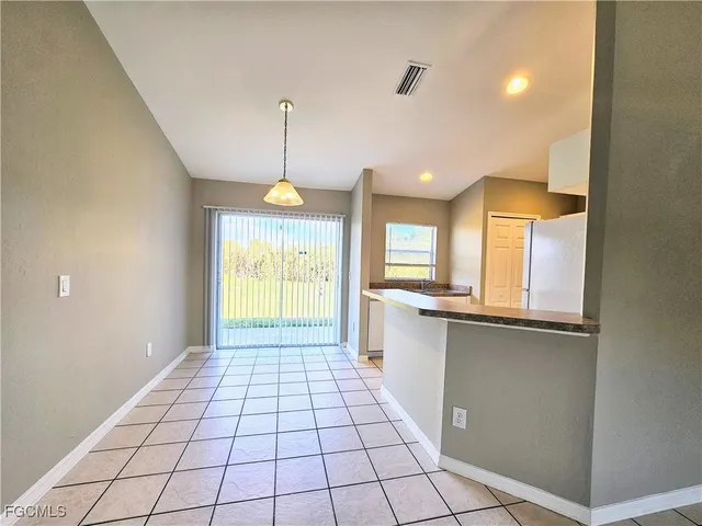 a view of a kitchen with a sink and cabinets