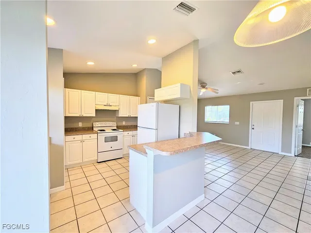 a open kitchen with stainless steel appliances kitchen island granite countertop a sink and cabinets