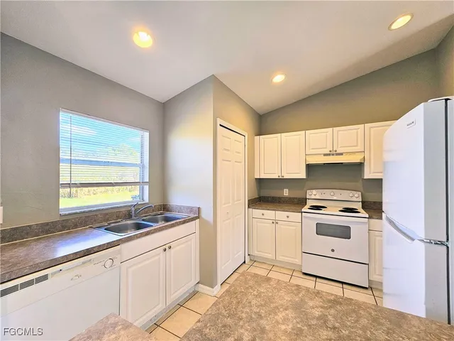 a kitchen with a stove a sink and a refrigerator