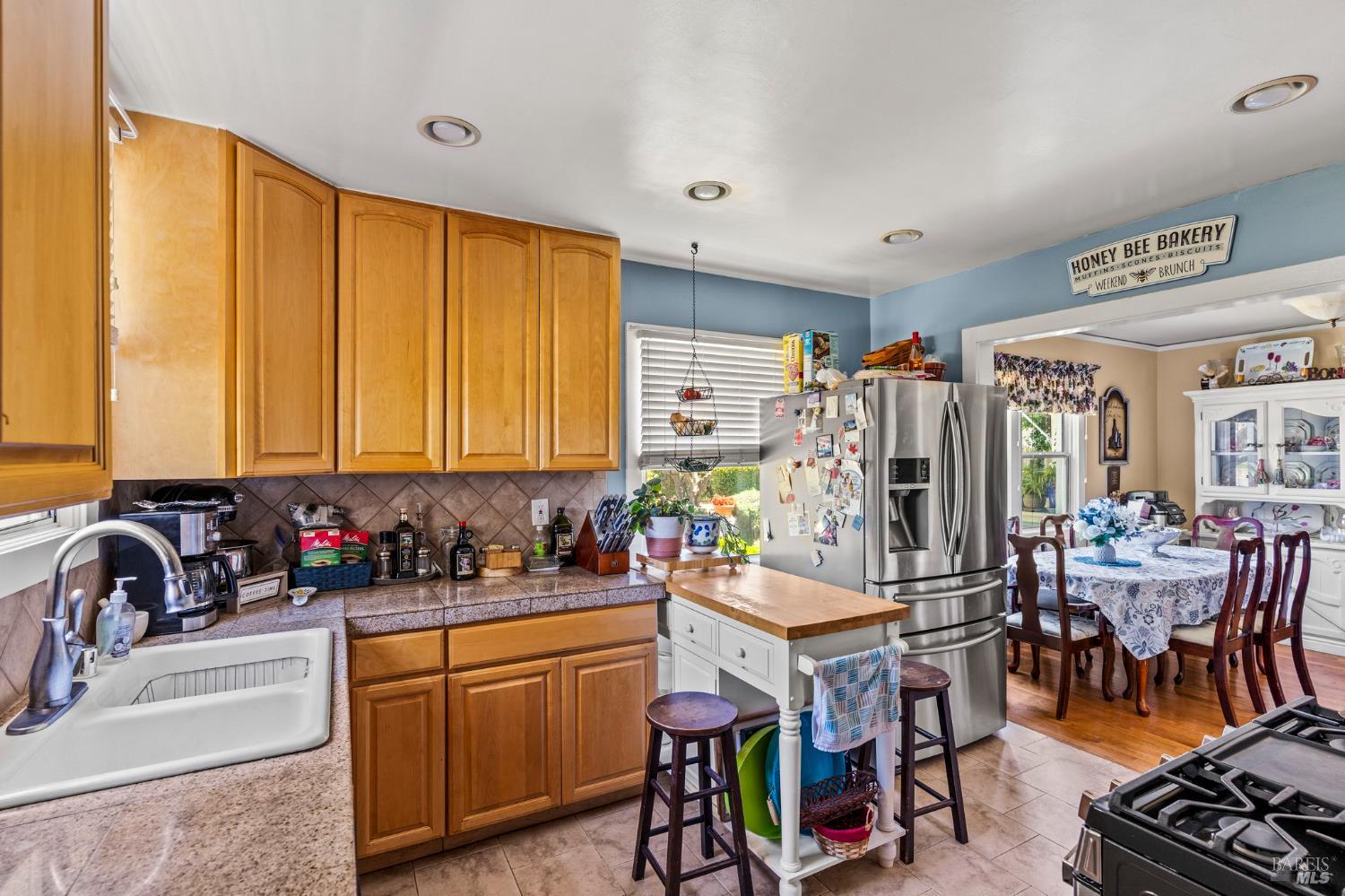 1225 Oakville Grade Road Oakville, CA 94558 - Photo 15 of 76 a view of a kitchen with kitchen island granite countertop a large window and chairs