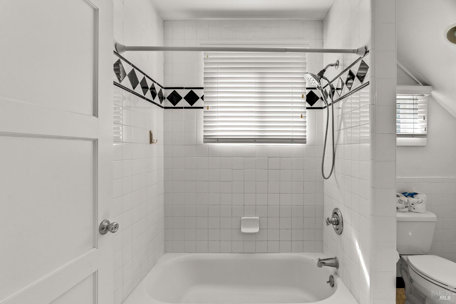 1225 Oakville Grade Road Oakville, CA 94558 - Photo 47 of 76 a bathroom with a window a bathtub and a shower