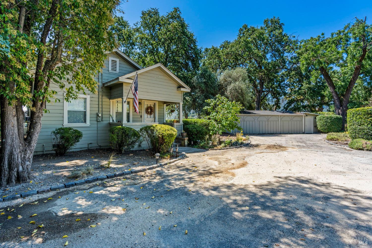 1225 Oakville Grade Road Oakville, CA 94558 - Photo 49 of 76 a view of a house with a yard plants and large tree