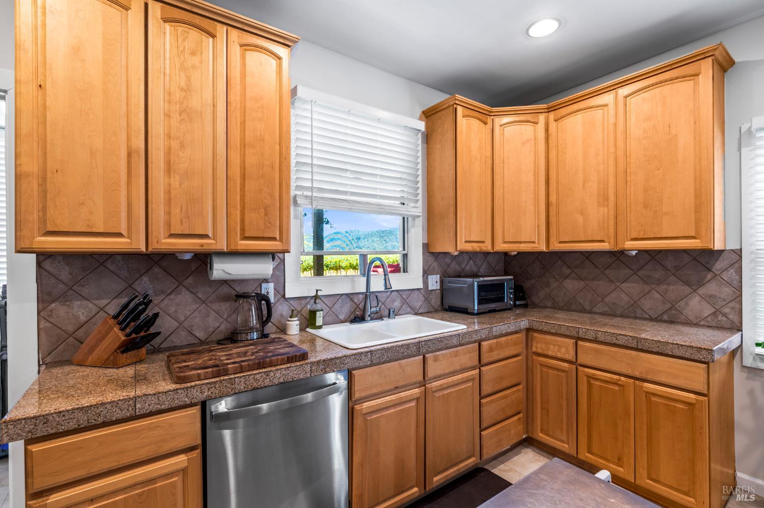 1225 Oakville Grade Road Oakville, CA 94558 - Photo 58 of 76 a kitchen with stainless steel appliances granite countertop sink stove and cabinets