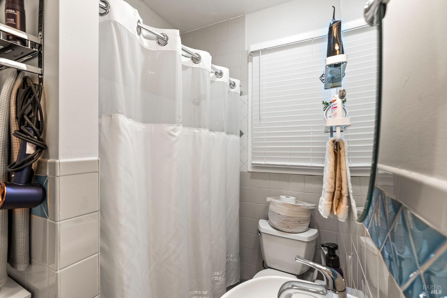 1225 Oakville Grade Road Oakville, CA 94558 - Photo 61 of 76 a bathroom with a toilet and a shower curtain
