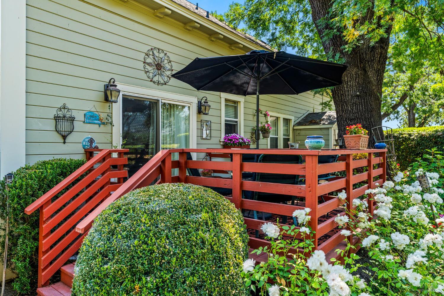 1225 Oakville Grade Road Oakville, CA 94558 - Photo 7 of 76 a backyard of a house with table and chairs under an umbrella