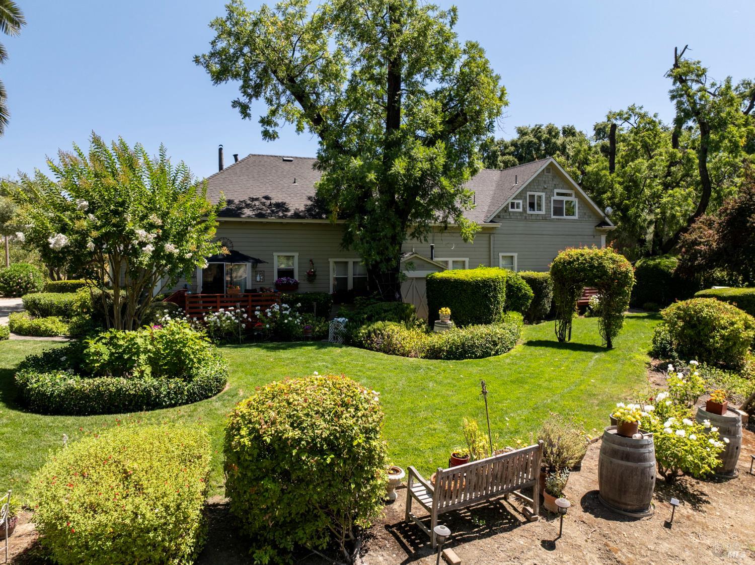1225 Oakville Grade Road Oakville, CA 94558 - Photo 75 of 76 a front view of a house with a garden and plants