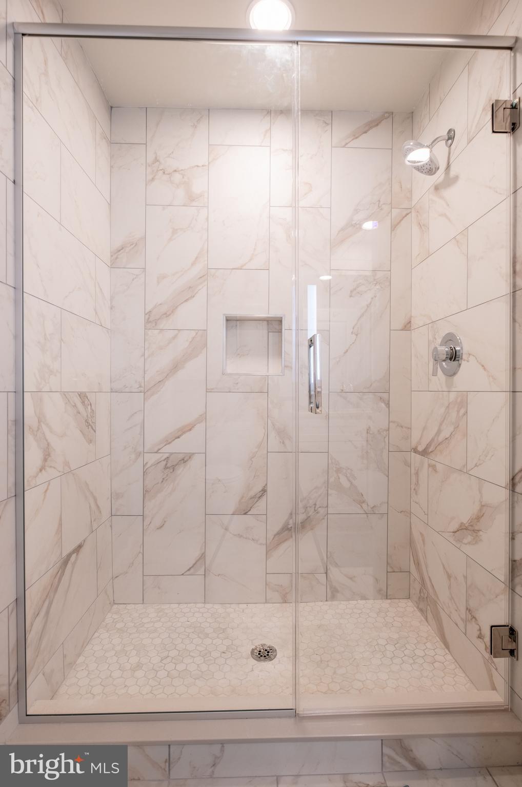 2301-61 John F Kennedy Boulevard, Unit 105 Philadelphia, PA 19103 - Photo 15 of 42 a bathroom with a shower