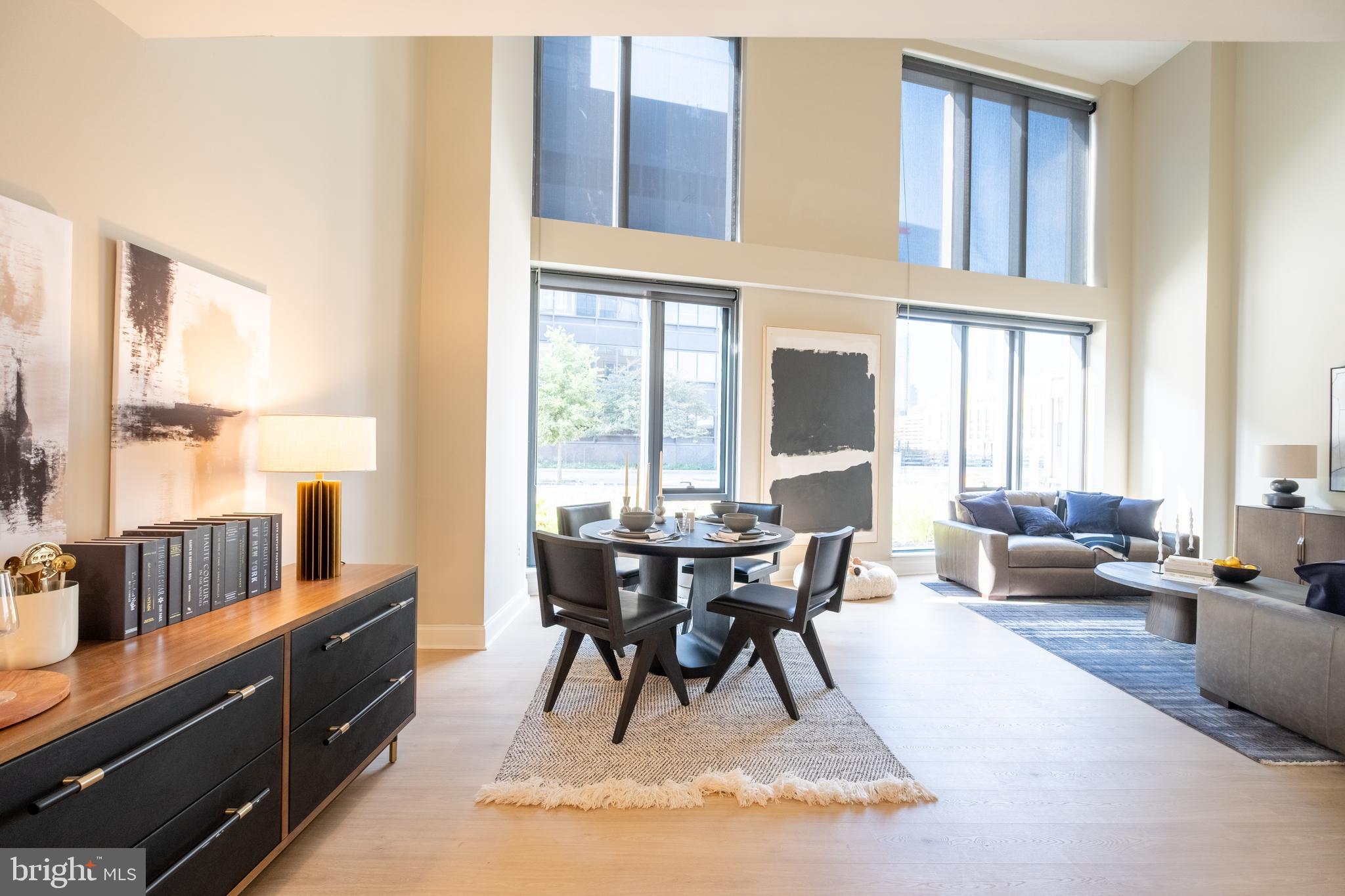 2301-61 John F Kennedy Boulevard, Unit 105 Philadelphia, PA 19103 - Photo 9 of 42 a view of a dining room with furniture window and wooden floor