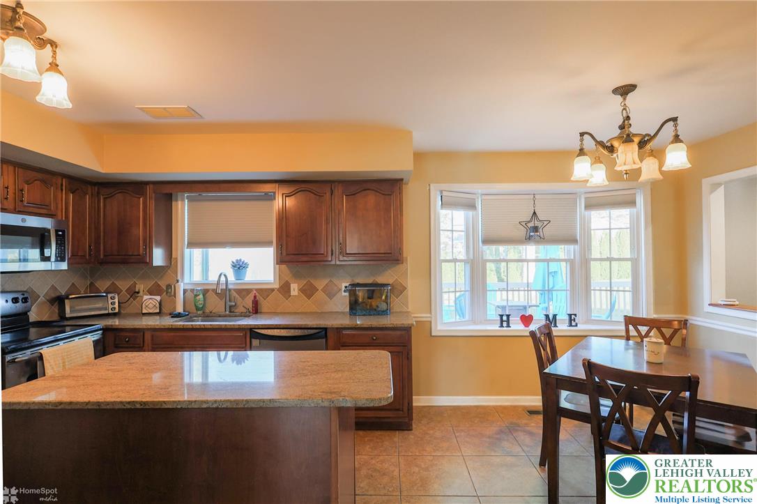 3657 Gramercy Place Bethlehem, PA 18020 - Photo 16 of 86 a kitchen with stainless steel appliances granite countertop a stove a sink and a dining table with granite countertops