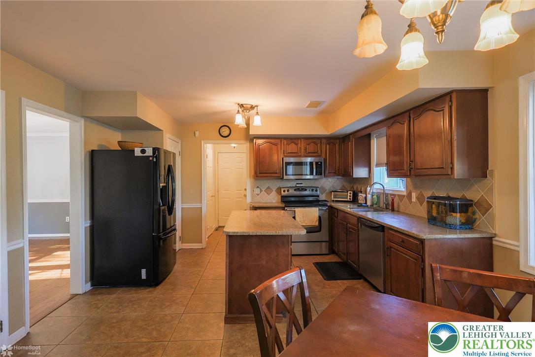 3657 Gramercy Place Bethlehem, PA 18020 - Photo 19 of 86 a kitchen with stainless steel appliances granite countertop a refrigerator a stove top oven a sink and dishwasher