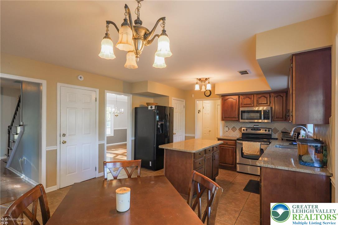 3657 Gramercy Place Bethlehem, PA 18020 - Photo 20 of 86 a kitchen with stainless steel appliances kitchen island granite countertop a refrigerator a stove and a sink with wooden floor