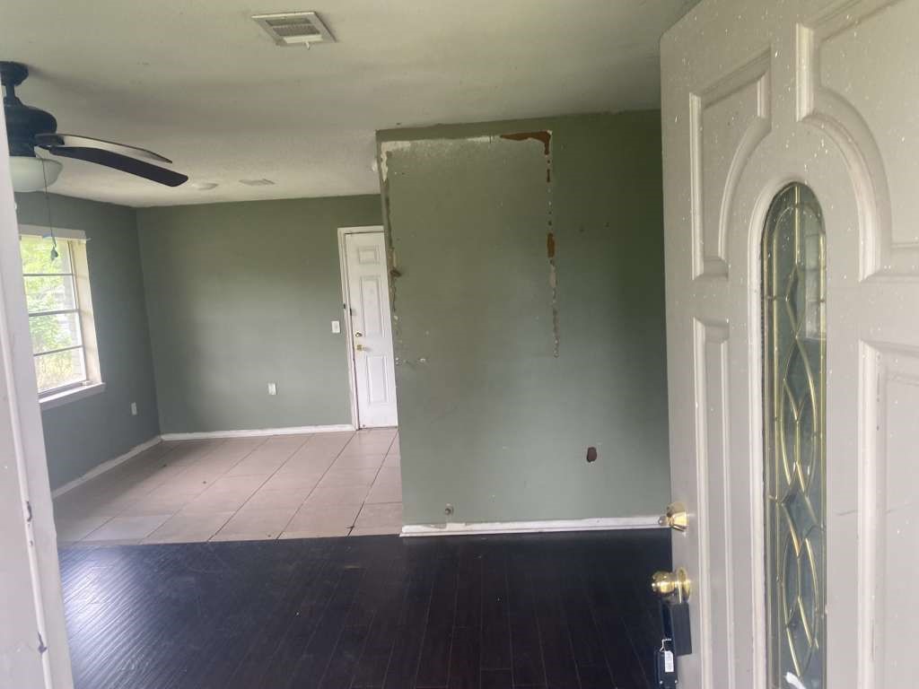 503 Willow Street Rosenberg, TX 77471 - Photo 3 of 11 an empty room with wooden floor and a window