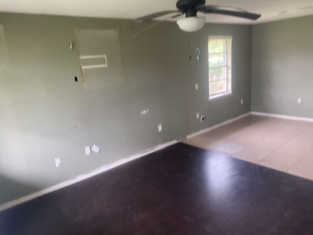 503 Willow Street Rosenberg, TX 77471 - Photo 8 of 11 wooden floor in an empty room with a window