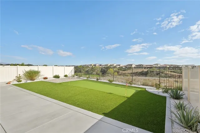 a view of a swimming pool and a yard