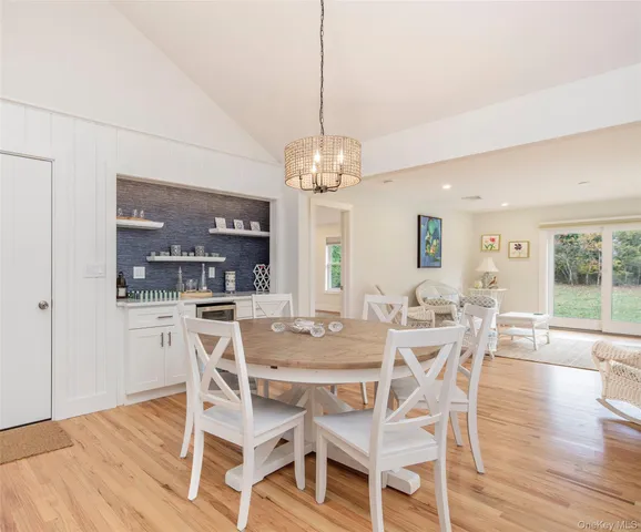 a view of a dining room with furniture wooden floor and chandelier