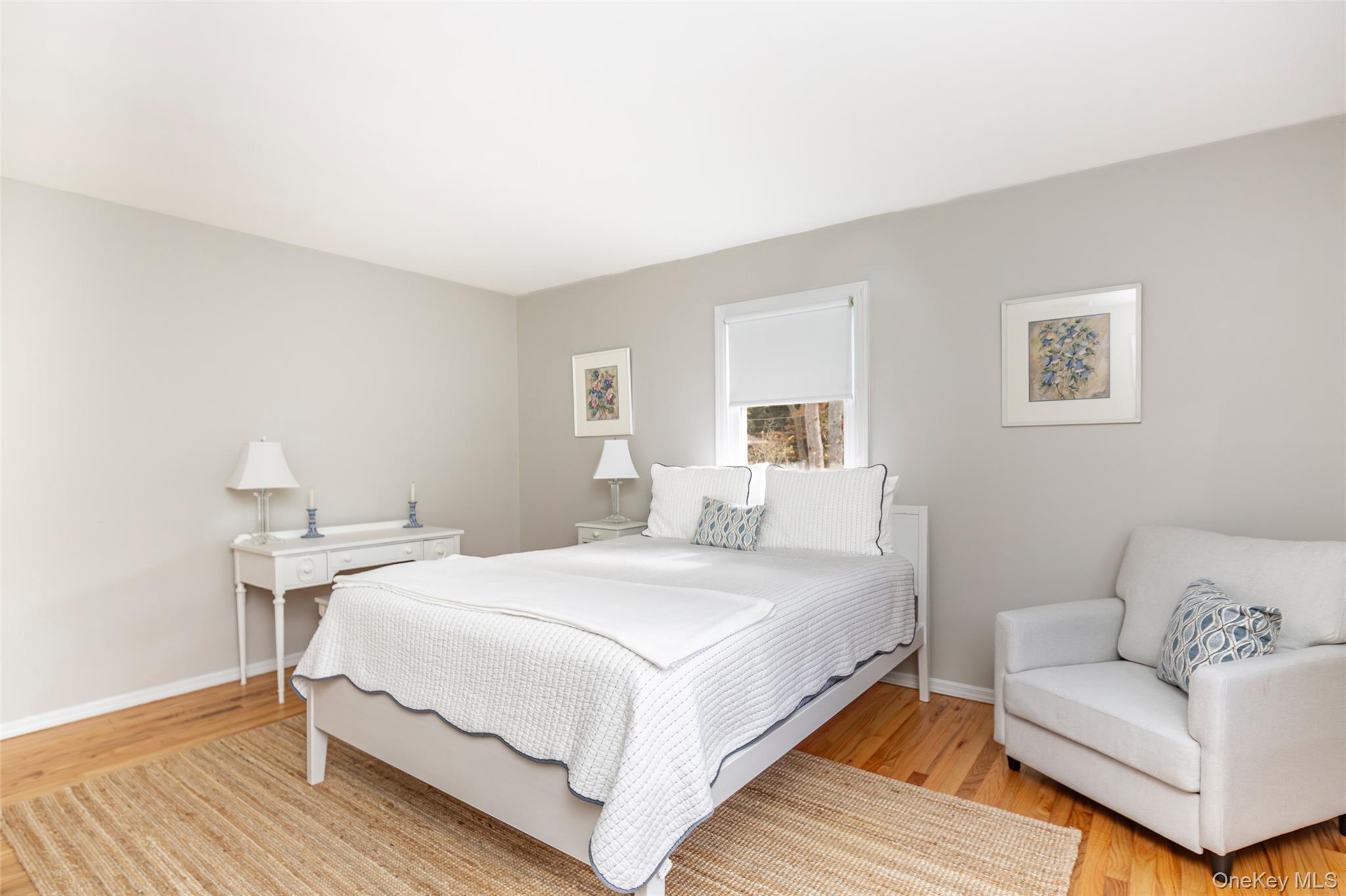 64 Aspatuck Road Westhampton Beach, NY 11978 - Photo 10 of 11 a bedroom with a bed and a couch