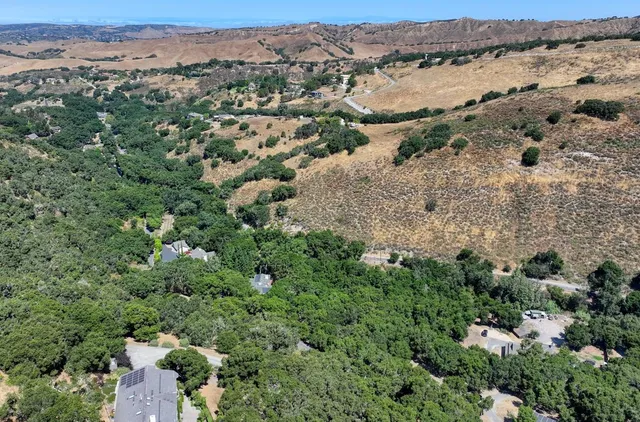 an aerial view of a houses with a yard