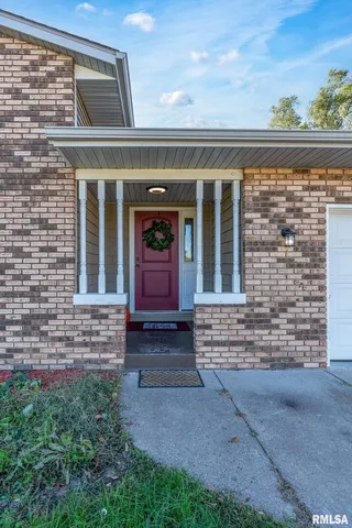 front view of a brick house with large windows