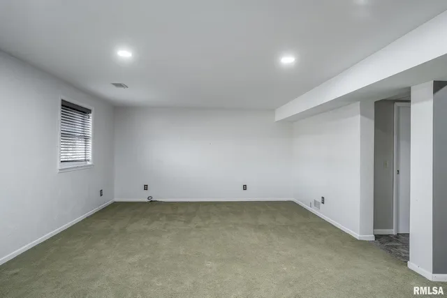 an empty room with a empty space and windows