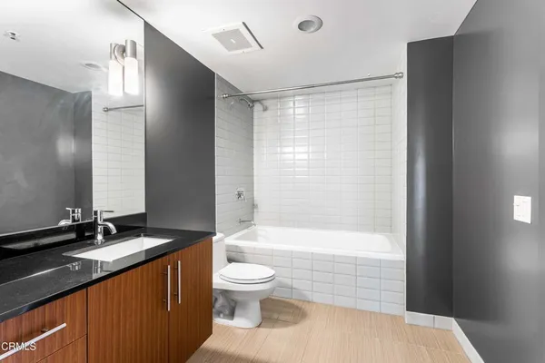 a bathroom with a double vanity sink toilet and shower
