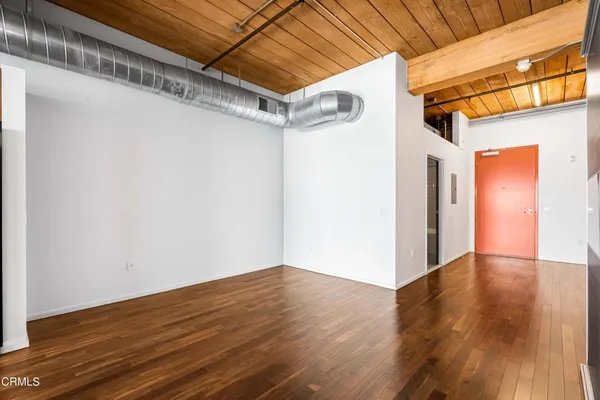 a view of a room with wooden floor
