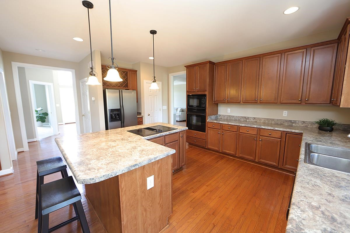 6017 Jones Farm Road Wake Forest, NC 27587 - Photo 6 of 25 Don't miss the built in wine rack above the Refrigerator. Lots of cabinets adorn this spacious kitchen. Kitchen