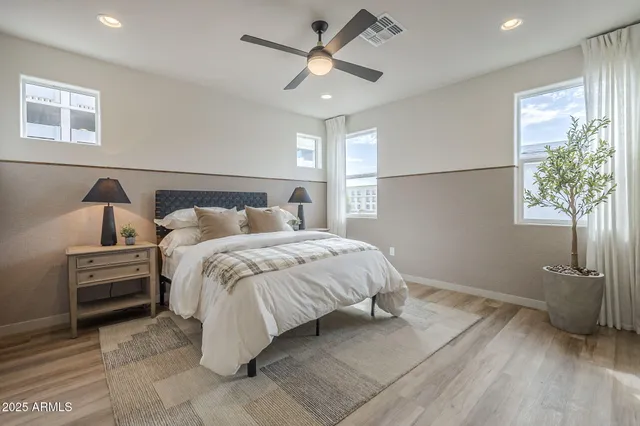 a bedroom with a bed and a chandelier