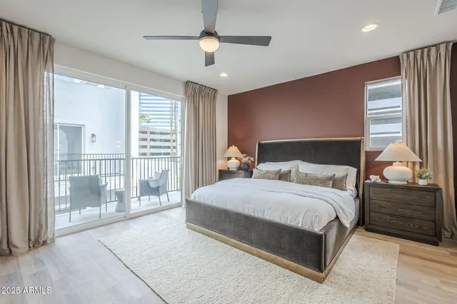 a bedroom with a large bed and a chandelier