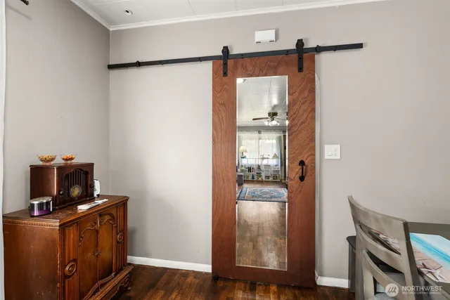 a view of a hallway with workspace and wooden floor