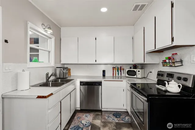 a kitchen with a sink stove and cabinets