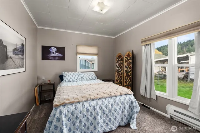 a bedroom with a large bed and a window