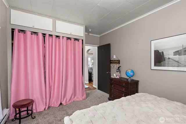 a bedroom with a bed and a chair in it