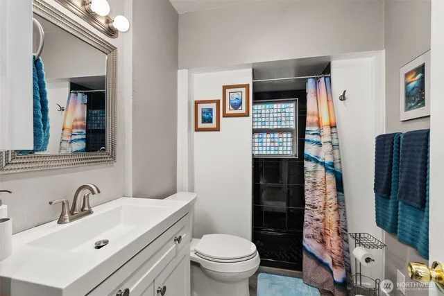 a bathroom with a sink toilet and shower
