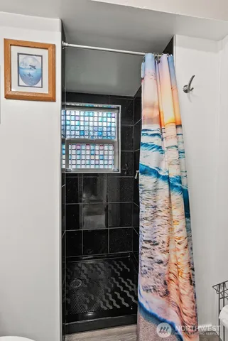 a bathroom with a shower and a sink