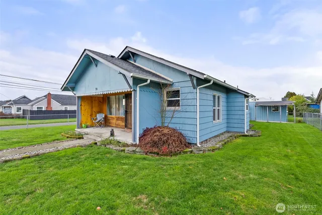 a view of a house with a yard and sitting area