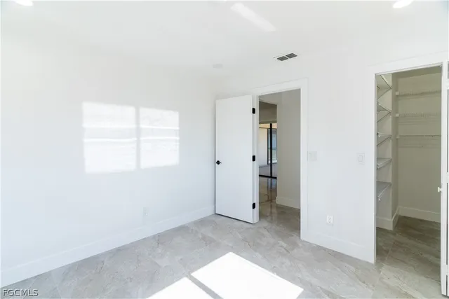 a bathroom with a granite countertop sink mirror vanity and toilet