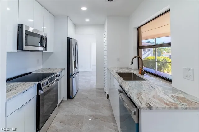 a kitchen with a stove a sink and a microwave