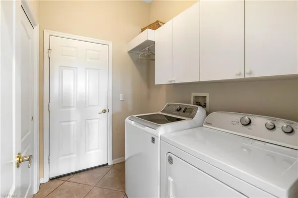 a view of washer and dryer with kitchen in the background