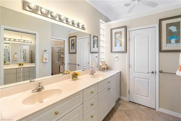a bathroom with a double vanity sink mirror and