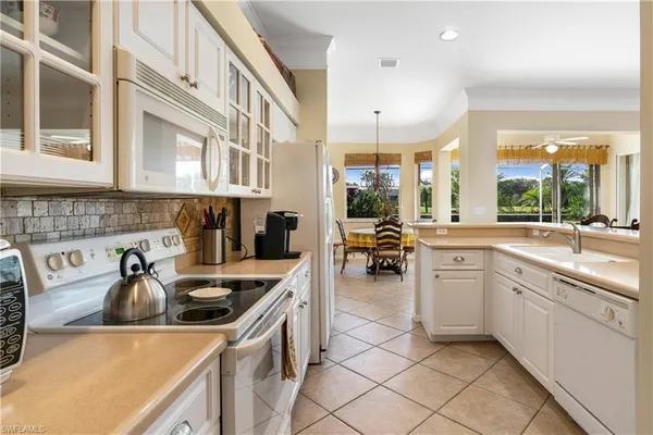 a kitchen with a sink a stove and cabinets