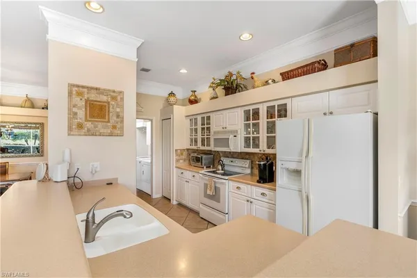 a kitchen with stainless steel appliances a stove a sink and a refrigerator