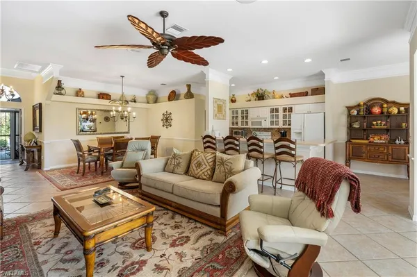 a living room with furniture ceiling fan and a rug