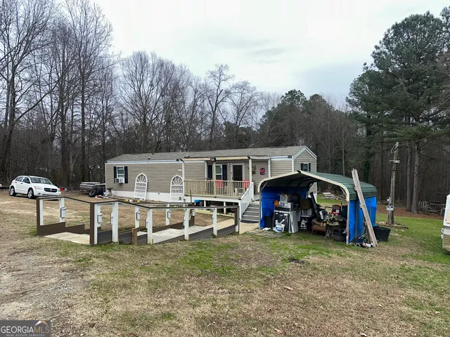 a view of a house with a yard and furniture