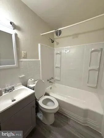 a bathroom with a toilet sink and shower