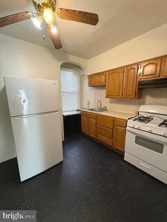 a kitchen with stainless steel appliances granite countertop a refrigerator a stove a sink and a refrigerator