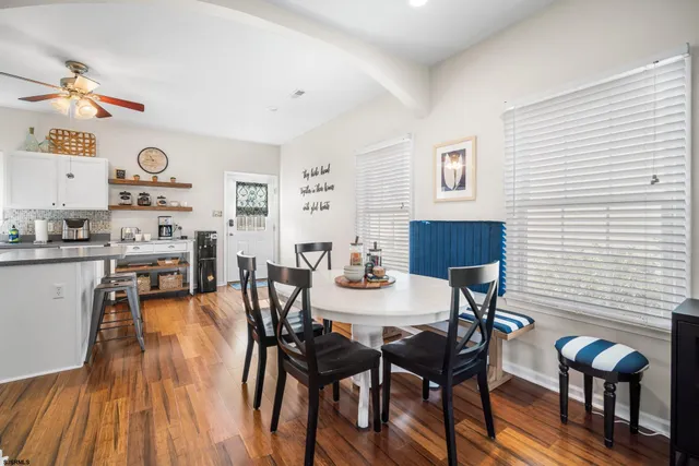 a view of a dining room with furniture and wooden floor
