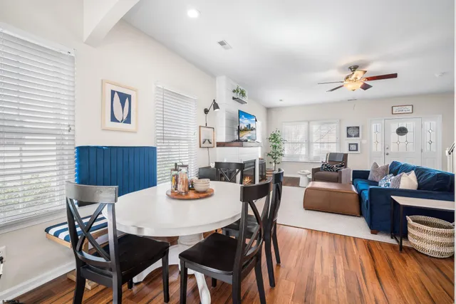 a view of a dining room with furniture and wooden floor