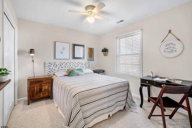 a bedroom with a bed and a desk