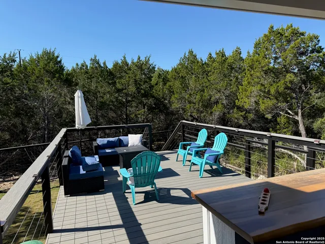 a view of a roof deck with wooden floor and a potted plant