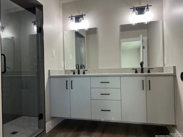 a bathroom with a double vanity sink and mirror